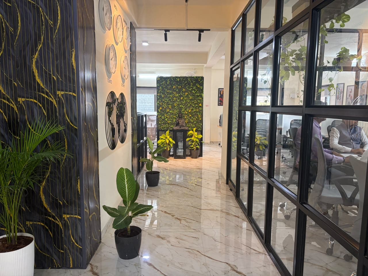 Executive corridor with world time zone clocks and indoor greenery