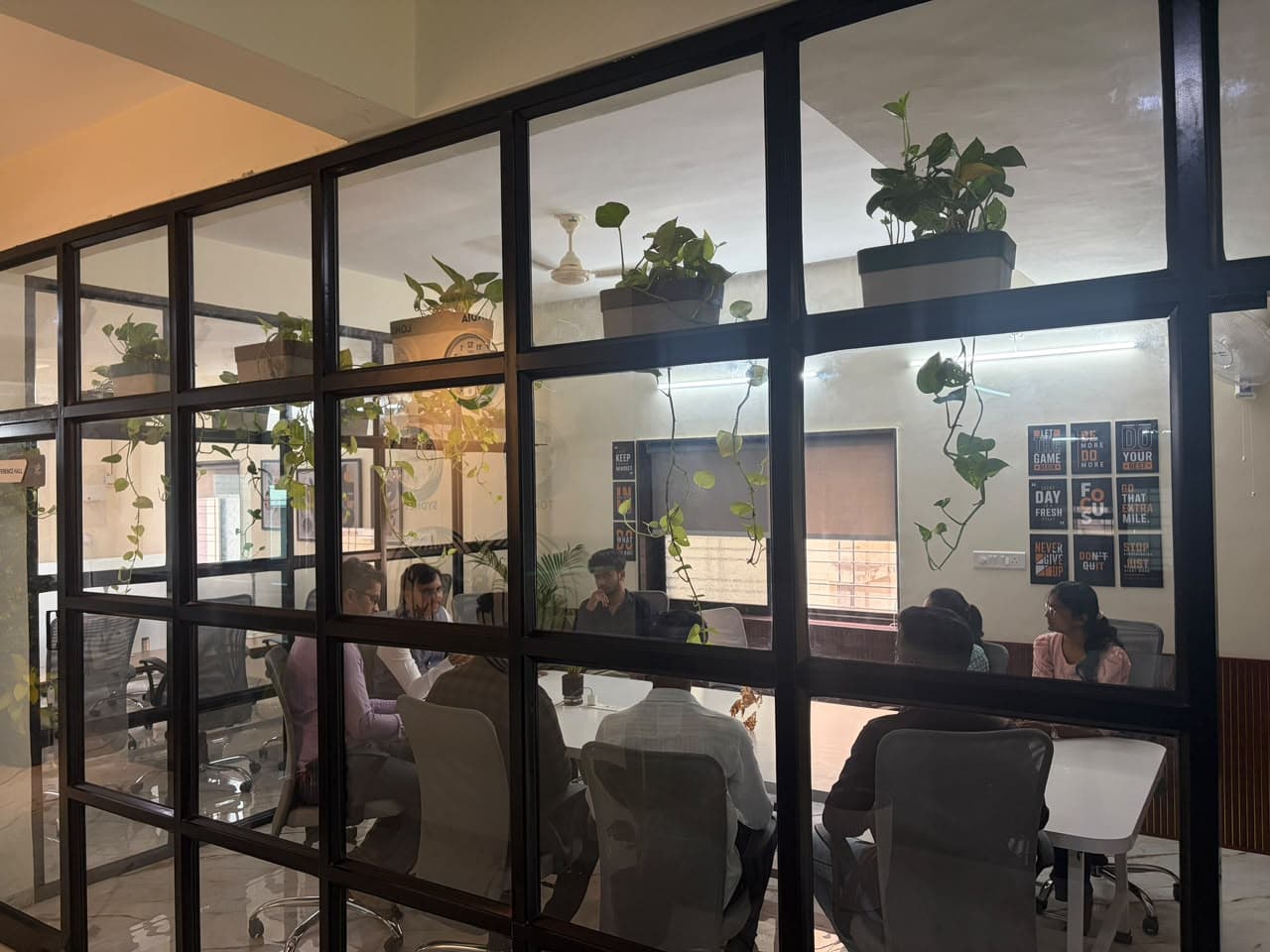 Executive meeting viewed through architectural glass partition